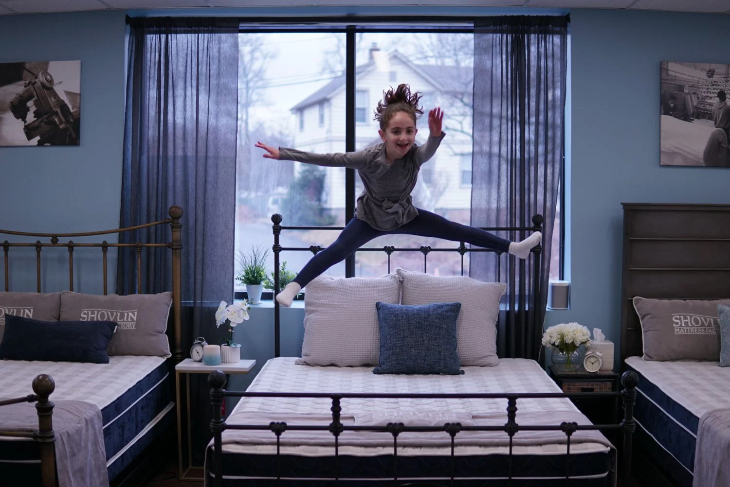 A child jumping on the mattress in the store
