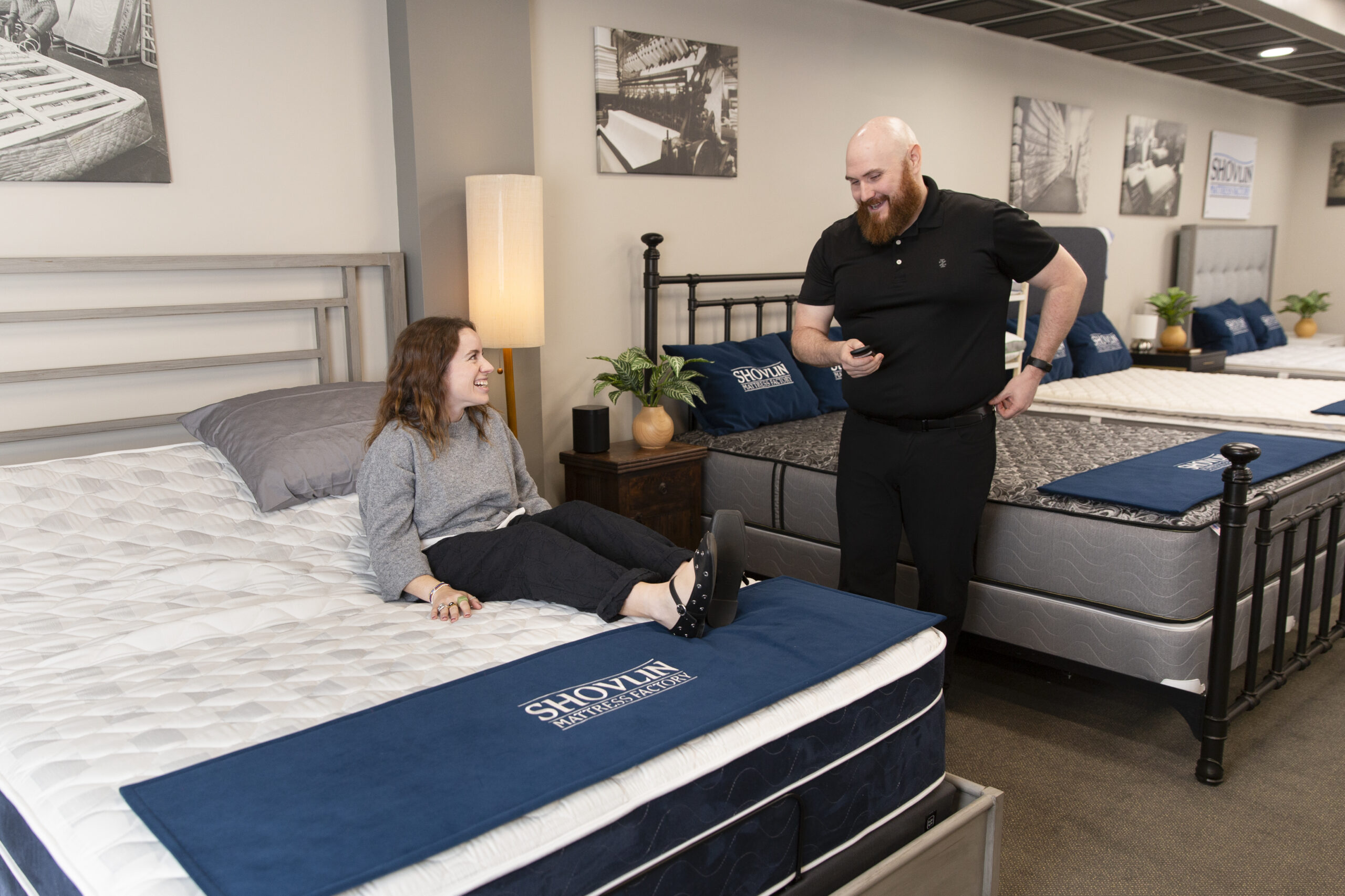 salesman explaining the qualities of the mattress